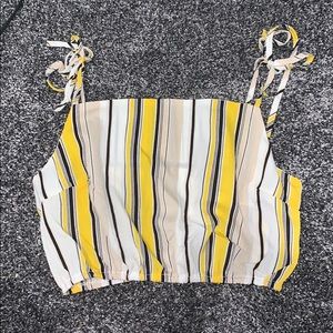 a yellow black white and tan crop top.